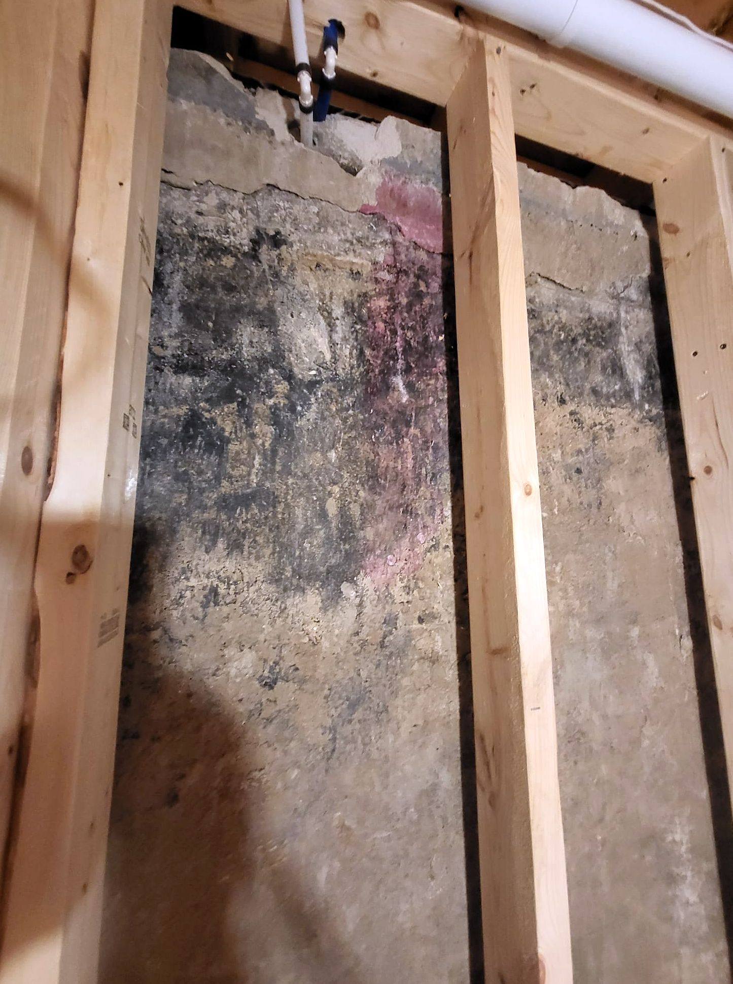 Water-stained basement framing before restoration