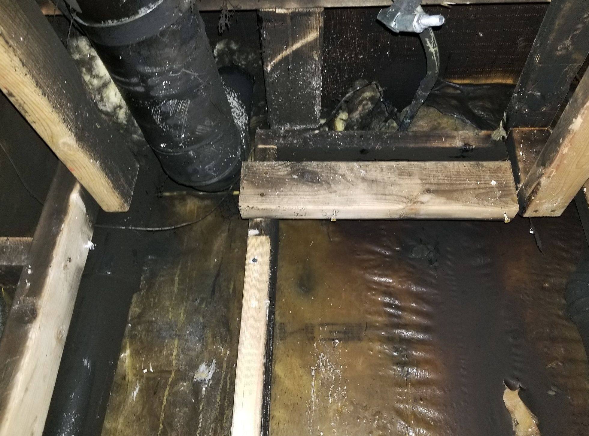 Fire-damaged floor joists at a job site